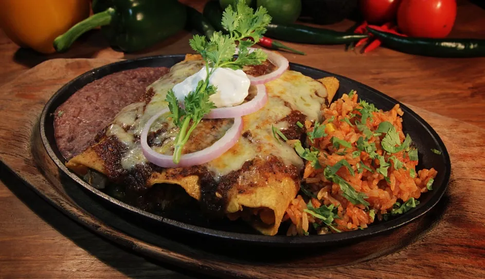 Enchiladas with sour cream and onion, refried beans and rice