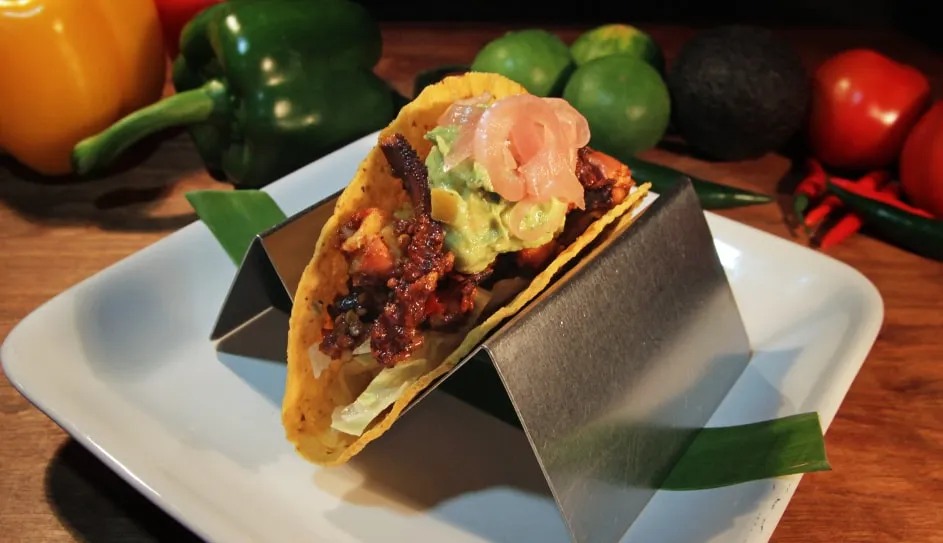 An octopus taco a la diabla in a taco stand